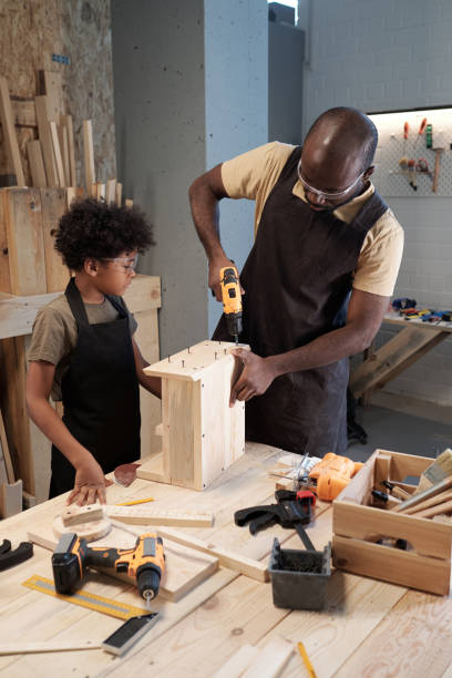 istock Black Man with Son in Carpentry Workshop 1371721624