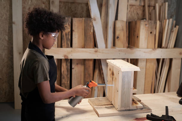 istock Boy Building Birdhouse Side View 1371721636