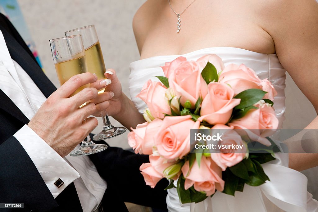 holiday champagne in hands of bride and groom Adult Stock Photo