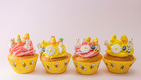 Easter Cupcakes with frosting decorated by Easter Bunnies, Chicks , Eggs, Bees, and flowers