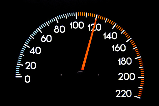 Closeup image of Speedometer with Needle Displaying 120