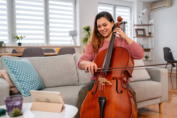 istock Young Woman Watching A Tutorial On Tablet On How To Play Cello 1371723474