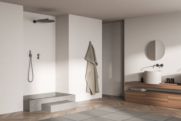 istock Corner view on bright bathroom interior with shower, round mirror 1371726755