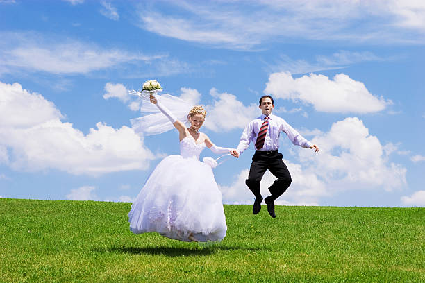 istock jumping newly-married couple 137172716