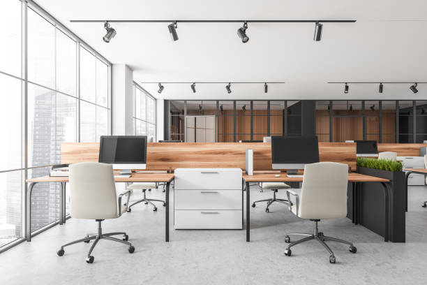 istock Bright office room interior with desktops, desks, armchairs, panoramic windows 1371727896