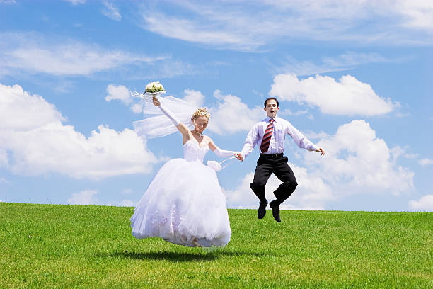 istock jumping newly-married couple 137173048