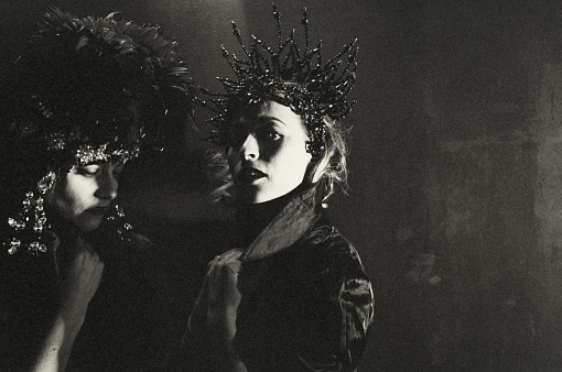 Portrait of two dancer in backstage. They stand in the twilight. It is cold and dark.