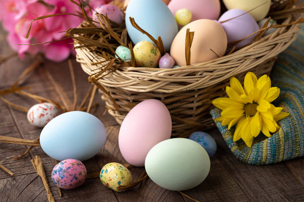 istock Pastel colored Easter eggs and candy in a bsket and on a table 1371734370
