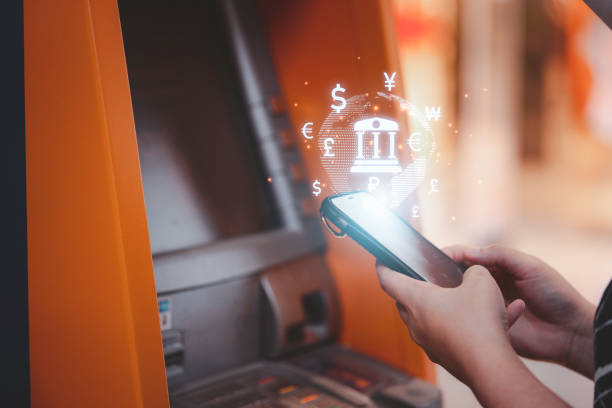 istock Woman hand using smartphone for transfer money between mobile phone and Automatic Teller Machine or ATM , Financial technology concept. 1371735798