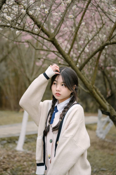 istock Young asian girls under cherry trees 1371736046
