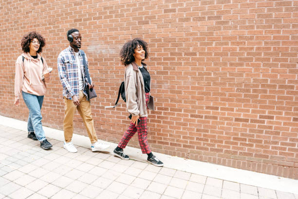 istock Group of students walking  outdoors 1371736484
