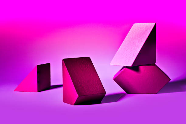istock Cool arrangement of differently shaped geometrical blocks on pink background 1371736553