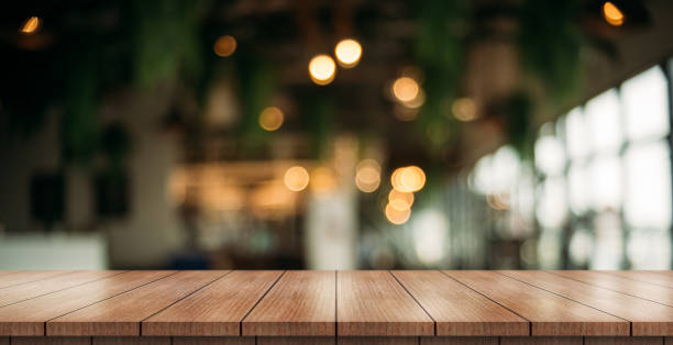 istock Empty wooden table top with lights bokeh on blur restaurant background. 1371744029