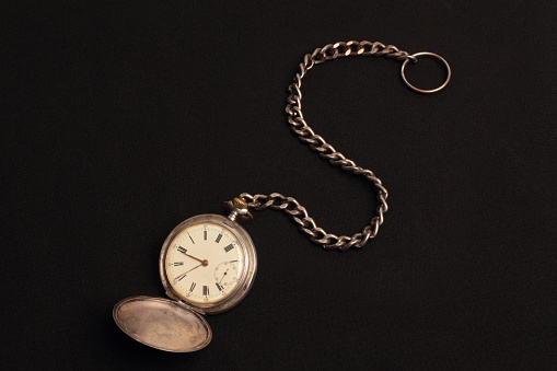 old pocket watch with black background