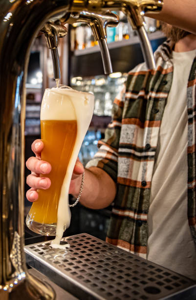istock bartender pouring a draught beer in glass serving in a bar or pub 1371745249