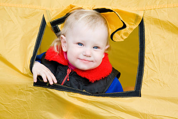 child in a tent stock photo