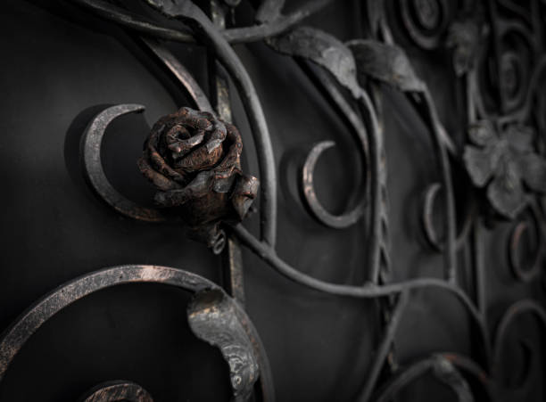 Ancient wrought rose in rust on a metal gate