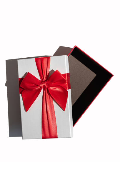 istock Opened gift box with lid and red ribbon isolated on white 1371746651