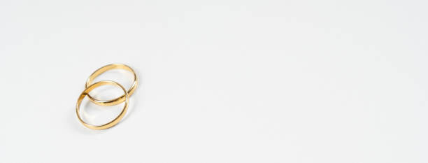 istock Gold wedding rings on a white background 1371746911