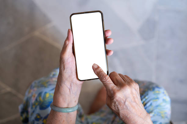 istock Senior woman using smart phone with blank white screen 1371748250