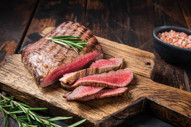 Barbecue dry aged wagyu Flank Steak on a cutting board. Wooden background. Top view Barbecue dry aged wagyu Flank Steak on a cutting board. Wooden background. Top view. steak stock pictures, royalty-free photos & images