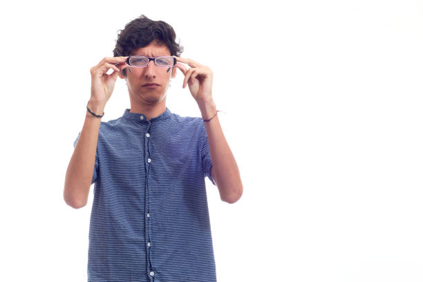 istock Man with glasses straining his eyes because he can't see well. 1371750615