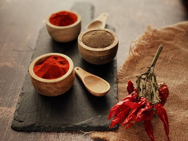 Background with different types of paprika: dry, sweet, hot and black paprika