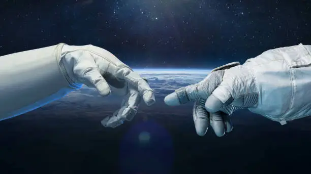 Photo of Astronaut in glove and robot hands in space. Earth planet on background. Technology and space flight. Elements of this image furnished by NASA
