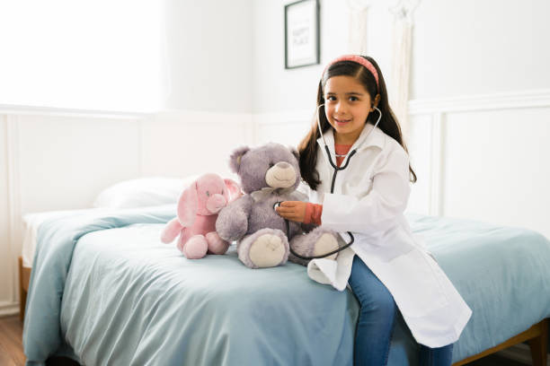 istock Child playing with a stethoscope and a teddy bear 1371759636