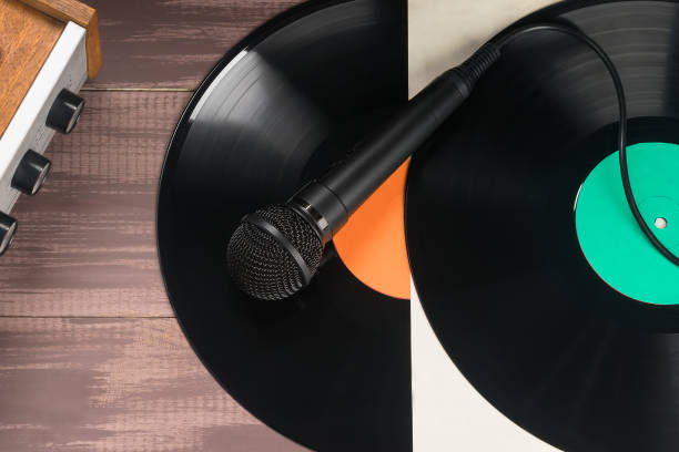 istock microphone lies on two vinyl records, top view 1371761432