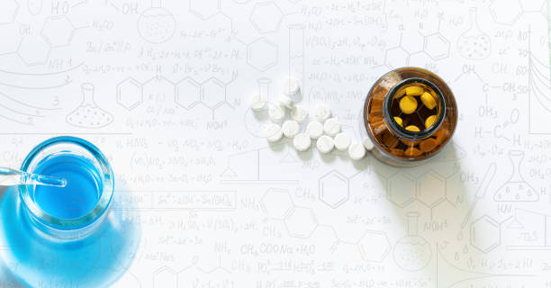 istock Pills and pill bottles on white background,Science glass test tube,Analyzing samples,Scientists have experimented with antibiotics in vitro,Hand drawn science formulas on chalkboard for background. 1371762076