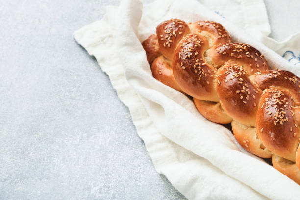 istock Sabbath kiddush ceremony composition. Challah bread. Freshly baked homemade braided challah bread for Shabbat and Holidays on light grey background, Shabbat Shalom. Top view. Copy space. 1371763837