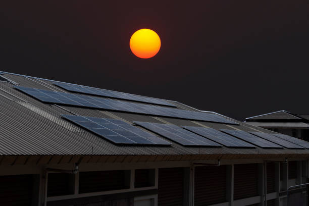 Close-up surface of lit by sun blue shiny solar photo voltaic panels system on building roof. Renewable ecological green energy production concept.