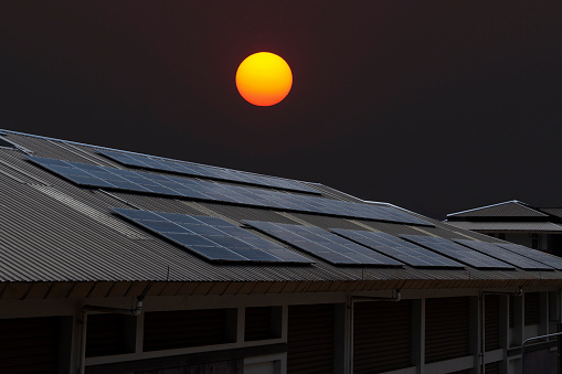 Solar cell panels on the roof on sunset background
