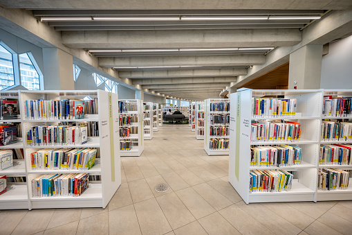 Calgary, Alberta - February 6, 2022: Interior of Calgary`s Central Branch of the Calgary Public Library. The library opened in November 2018 and was designed by renowned Snohetta firm.