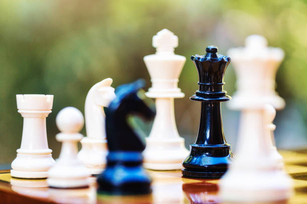 istock Daring black queen checkmates white king deep in his own territory on a chess board 1371767315