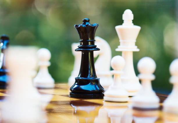 istock Daring black queen checkmates white king deep in his own territory on a chess board 1371767339