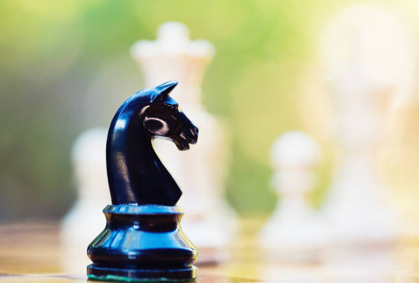 istock Lone black knight deep in white territory on a chessboard 1371767557