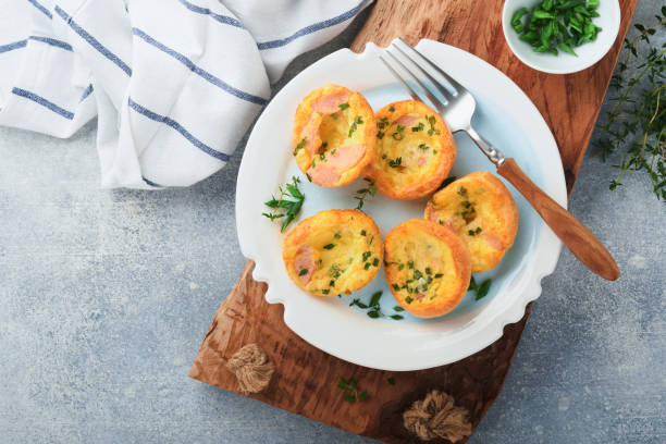 istock Egg muffins with green onions, bacon, cheese and tomatoes on white plate on light background. Healthy high protein and low carb breakfast, ready to eat. 1371767655