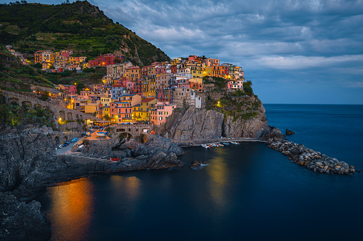One of the most famous fishing village of the world with colorful seaside houses on the cliffs at evening, Manarola, Cinque Terre, Liguria, Italy, Europe