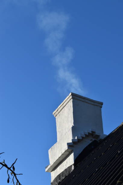 istock Smoke from an old chimney. The past in the precent. 1371780031
