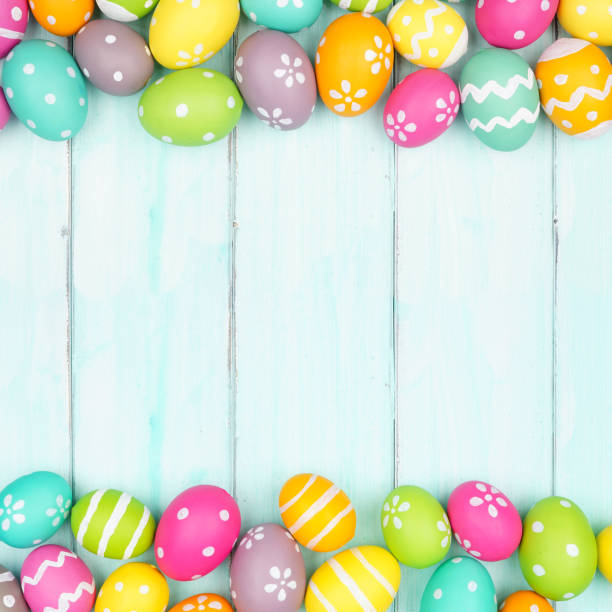 istock Colorful Easter Egg double border over a soft blue wood background 1371781074
