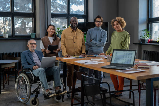 istock Cheerful economists of various ethnicities gathered by workplace 1371781614