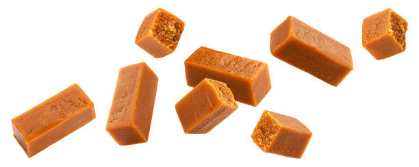 istock Flying caramel candies isolated on white background 1371781778