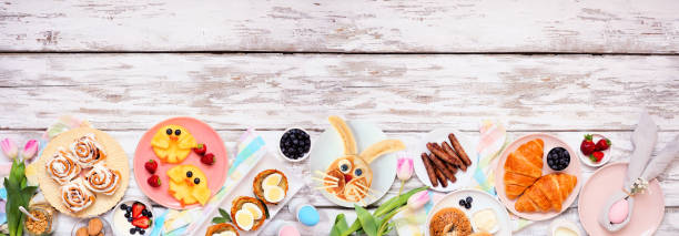 istock Easter breakfast or brunch bottom border. Top view on a white wood banner background. 1371781861