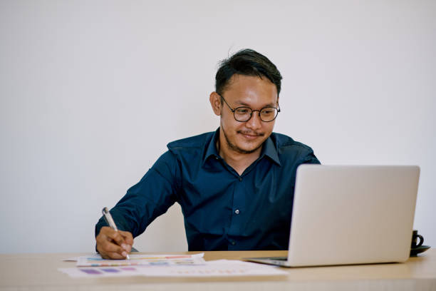 istock Asian businessman working using laptop in the office 1371781963