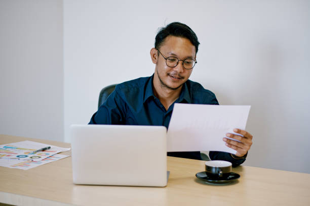 istock Asian businessman working using laptop in the office 1371781972