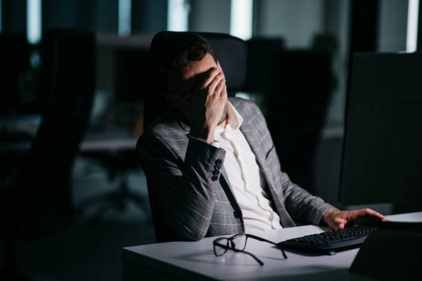 istock Stylish businessman exhausted at work at night 1371783532