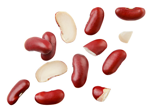 Beans red whole and pieces falling close-up on a white background, cut out. Isolated