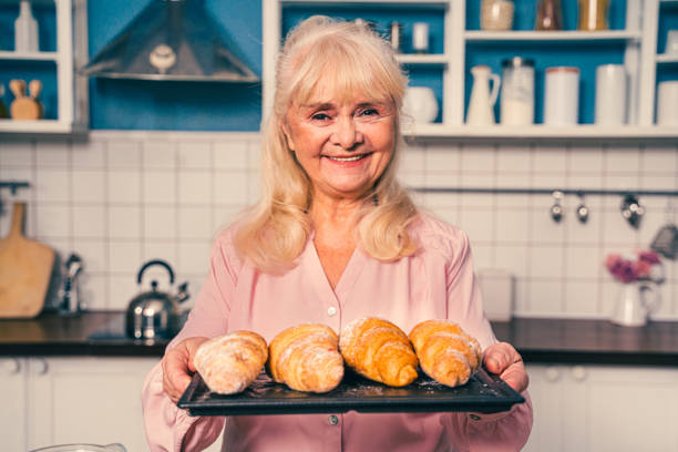 istock Beautiful senior woman baking in the kitchen 1371784544